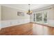 Elegant dining room with hardwood floors, chair rail, and large window for ample natural light at 5605 Preserve Cir, Johns Creek, GA 30005