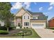 Beautiful home featuring a manicured lawn, fresh landscaping, and attached two-car garage at 5605 Preserve Cir, Johns Creek, GA 30005