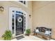 Charming front entrance with bench, mature plants, and decorative wreath, offering an inviting curb appeal at 5605 Preserve Cir, Johns Creek, GA 30005
