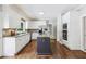 Bright kitchen with white cabinets, stainless steel appliances, and a dark kitchen island at 5605 Preserve Cir, Johns Creek, GA 30005