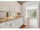Bright butler's pantry with granite counters, mirrored backsplash, and access to the dining room at 5605 Preserve Cir, Johns Creek, GA 30005