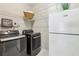 Functional laundry room with a washing machine, dryer, and ample storage space at 5605 Preserve Cir, Johns Creek, GA 30005