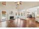 Bright and airy living room boasts hardwood floors, fireplace, and views of the backyard pool at 5605 Preserve Cir, Johns Creek, GA 30005