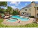 Backyard pool featuring an attached hot tub, palm tree, lounge area, and lawn chairs at 5605 Preserve Cir, Johns Creek, GA 30005