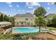 Gorgeous in-ground pool with attached spa and patio area, perfect for outdoor relaxation and entertainment at 5605 Preserve Cir, Johns Creek, GA 30005