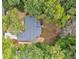 Aerial view of a house showing the roof, surrounding trees, and landscaping at 1329 Hidden Hills Pkwy, Stone Mountain, GA 30088