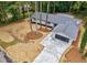 Aerial view of a beautifully renovated home with a modern garage, fresh landscaping, and private wooded lot at 1329 Hidden Hills Pkwy, Stone Mountain, GA 30088