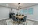 Formal dining area with modern chandelier, three windows, and stylish decor at 1329 Hidden Hills Pkwy, Stone Mountain, GA 30088