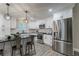 Modern kitchen features stainless appliances, subway tile backsplash, granite countertops, and seating at peninsula at 1329 Hidden Hills Pkwy, Stone Mountain, GA 30088