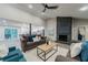 Cozy living room featuring a stone fireplace, modern ceiling fan, and stylish furnishings at 1329 Hidden Hills Pkwy, Stone Mountain, GA 30088