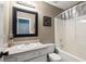 Traditional bathroom featuring a white vanity, framed mirror, and a bathtub with a shower curtain at 148 White Pine Ln, Temple, GA 30179