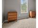 Bedroom with carpet, neutral walls, natural light, and two wooden dressers at 148 White Pine Ln, Temple, GA 30179