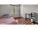Bedroom with wood floors, neutral walls, natural light, and a small desk at 148 White Pine Ln, Temple, GA 30179