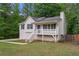 Well-kept home featuring a welcoming front porch, neat yard, and mature trees at 148 White Pine Ln, Temple, GA 30179