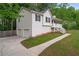 Exterior view of home showing garage, side yard, and walkway to front porch at 148 White Pine Ln, Temple, GA 30179