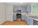 This kitchen has stainless steel appliances, contemporary cabinetry and lighting at 148 White Pine Ln, Temple, GA 30179