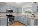 The kitchen showcases modern appliances and stylish cabinetry, complemented by a bright, airy atmosphere at 148 White Pine Ln, Temple, GA 30179