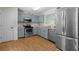 Well-lit kitchen featuring stainless steel appliances, and contemporary cabinetry at 148 White Pine Ln, Temple, GA 30179