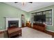 Comfortable living room with fireplace, providing ample natural light through large windows at 148 White Pine Ln, Temple, GA 30179