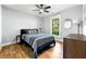 Bedroom featuring light walls, wood-look flooring, ceiling fan and natural light at 1921 Hazelwood Se Dr, Marietta, GA 30067