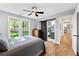 Bedroom with natural light, barn door to bath, wood-look flooring, and closet at 1921 Hazelwood Se Dr, Marietta, GA 30067