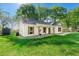 Beautiful white house with wood trim, green lawn, and trees at 1921 Hazelwood Se Dr, Marietta, GA 30067
