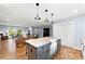 Bright, open kitchen with gray island and pendant lighting flows into living and dining areas at 1921 Hazelwood Se Dr, Marietta, GA 30067
