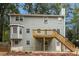 Home exterior with a wooden deck, wood siding, and an enclosed sunroom at 1960 Mceachern Manor Sw Dr, Marietta, GA 30064