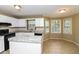 Well-lit kitchen with white cabinets, granite countertops, and stainless steel appliances at 1960 Mceachern Manor Sw Dr, Marietta, GA 30064