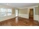 Bright living room featuring hardwood floors, wainscoting, and a door to the outdoor deck at 1960 Mceachern Manor Sw Dr, Marietta, GA 30064