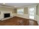Living room showcasing a brick fireplace, hardwood floors, and ample natural light at 1960 Mceachern Manor Sw Dr, Marietta, GA 30064