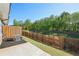 A spacious backyard with a wooden fence and green lawn, perfect for outdoor activities and relaxation at 2946 Stockholm Way, Suwanee, GA 30024