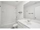 Bright white bathroom with a shower-tub combo, a toilet, and a large countertop with a mirror at 2946 Stockholm Way, Suwanee, GA 30024