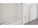 Well-lit bathroom with a soaking tub and a separate glass shower at 2946 Stockholm Way, Suwanee, GA 30024