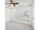 Bright bedroom featuring a ceiling fan and a large window with bright lighting at 2946 Stockholm Way, Suwanee, GA 30024