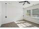 Bright bedroom featuring two hanging lights, gray-toned floors, natural light and a modern ceiling fan at 2946 Stockholm Way, Suwanee, GA 30024