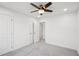 Bedroom featuring a modern ceiling fan and a closet with double doors at 2946 Stockholm Way, Suwanee, GA 30024