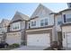 Charming townhome featuring brick and grey shingle facade, attached garage and well-maintained landscaping at 2946 Stockholm Way, Suwanee, GA 30024