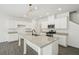 Bright kitchen with white cabinets, granite counters, stainless steel appliances and a large kitchen island at 2946 Stockholm Way, Suwanee, GA 30024