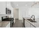 Kitchen showcasing stainless steel appliances, granite counters, white cabinets, and a kitchen island at 2946 Stockholm Way, Suwanee, GA 30024