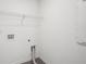 A bright white laundry room with gray floors and hookups for a washer and dryer at 2946 Stockholm Way, Suwanee, GA 30024