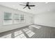 Inviting living room with bright natural light, gray floors, and access to the outdoor patio with white trim at 2946 Stockholm Way, Suwanee, GA 30024