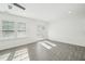 Inviting living room with bright natural light, gray floors, white trim and doors to the outdoor patio at 2946 Stockholm Way, Suwanee, GA 30024