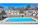 A beautiful swimming pool in the community, surrounded by well-maintained townhomes and lush landscaping at 2946 Stockholm Way, Suwanee, GA 30024