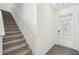Clean stairwell showing carpeted stairs, white trim, gray floors, and bright natural light at 2946 Stockholm Way, Suwanee, GA 30024