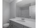 Contemporary bathroom with gray cabinets, a white sink, and a large mirror at 420 Tavistock Ct, Mcdonough, GA 30252
