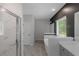 Bright bathroom featuring a soaking tub, marble accents, and a glass shower at 420 Tavistock Ct, Mcdonough, GA 30252