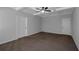Empty bedroom with beamed ceilings, neutral walls and carpet, and two doors at 420 Tavistock Ct, Mcdonough, GA 30252