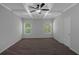 Empty bedroom with beamed ceilings, neutral walls and carpet, and two windows at 420 Tavistock Ct, Mcdonough, GA 30252