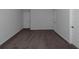 A carpeted bedroom featuring neutral walls, and a large doorway at 420 Tavistock Ct, Mcdonough, GA 30252